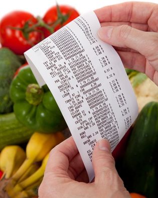 holding supermarket receipt