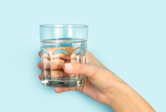 hand holding glass of water 