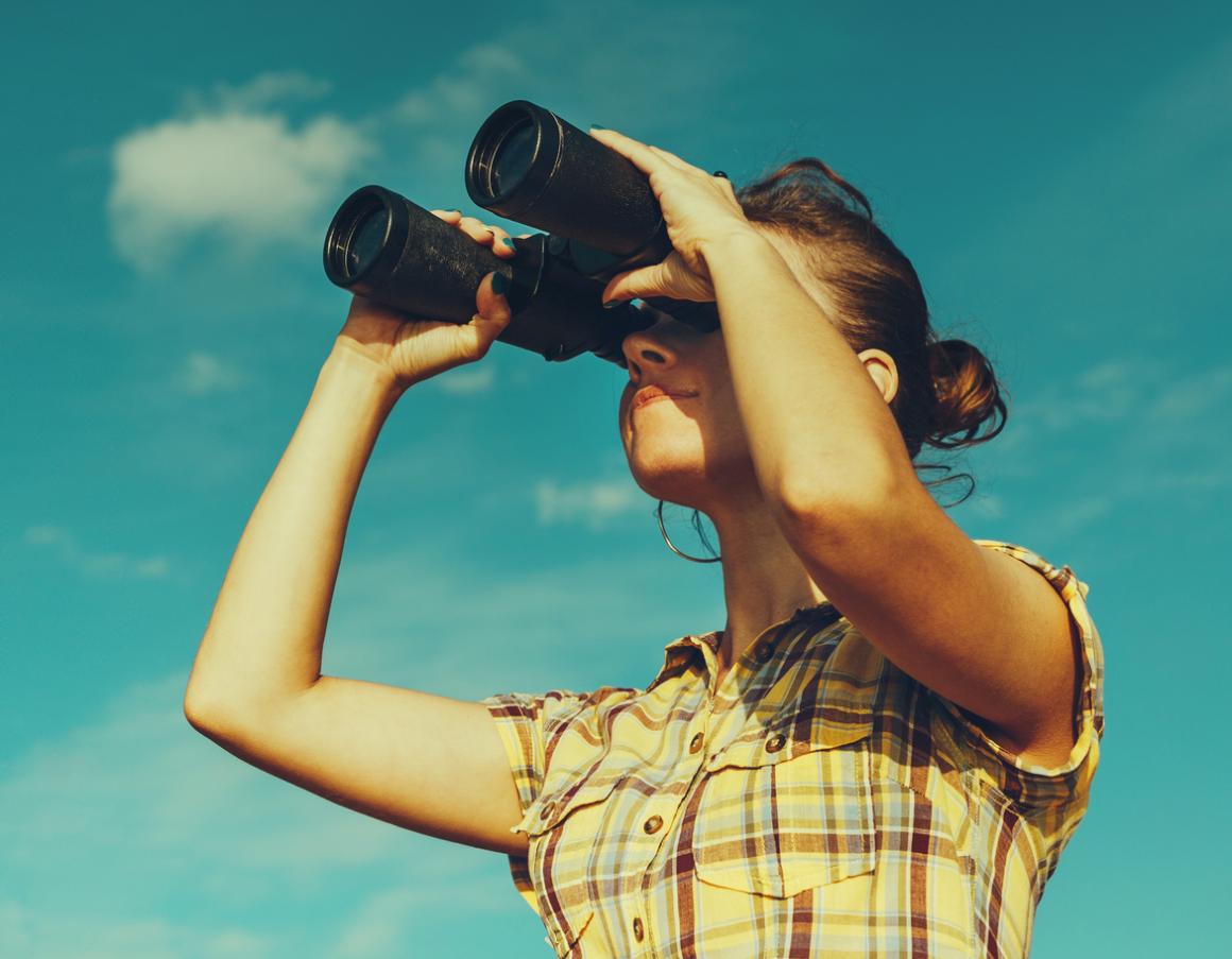 girl looking through binoculars