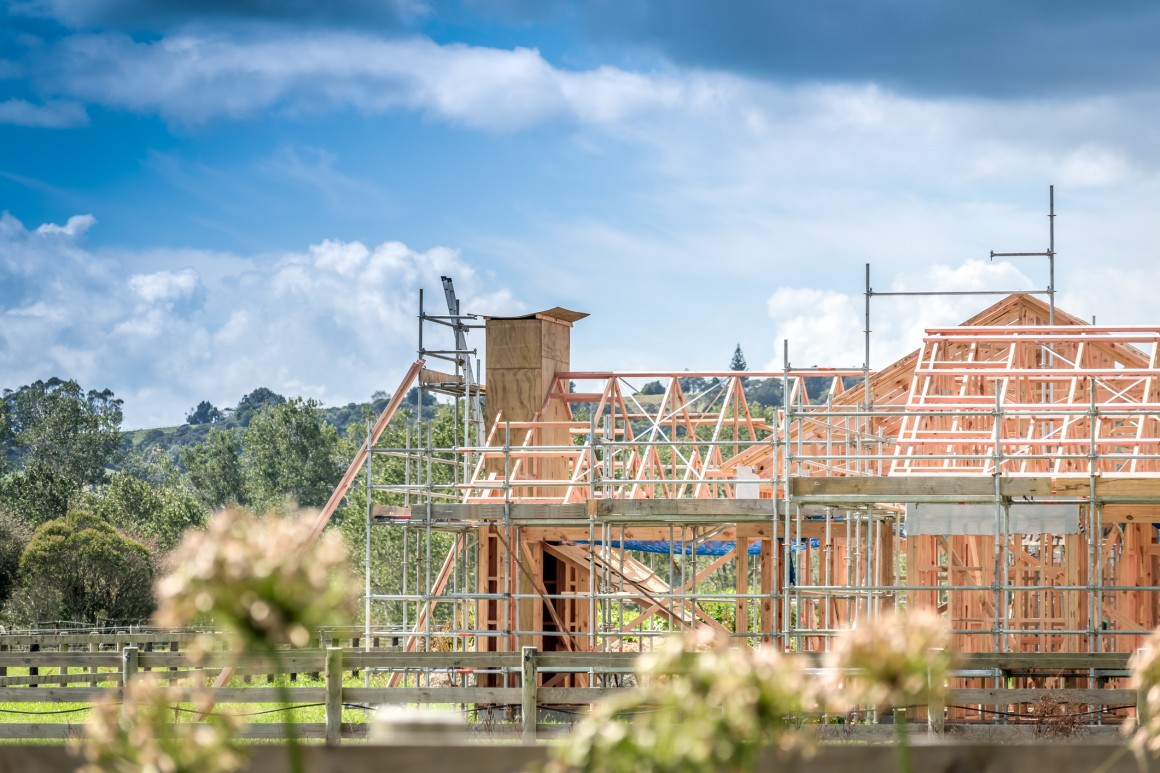 Construction of new house showing timber framing on a sunny day