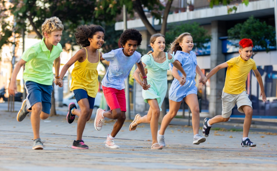 Tweens running on a street