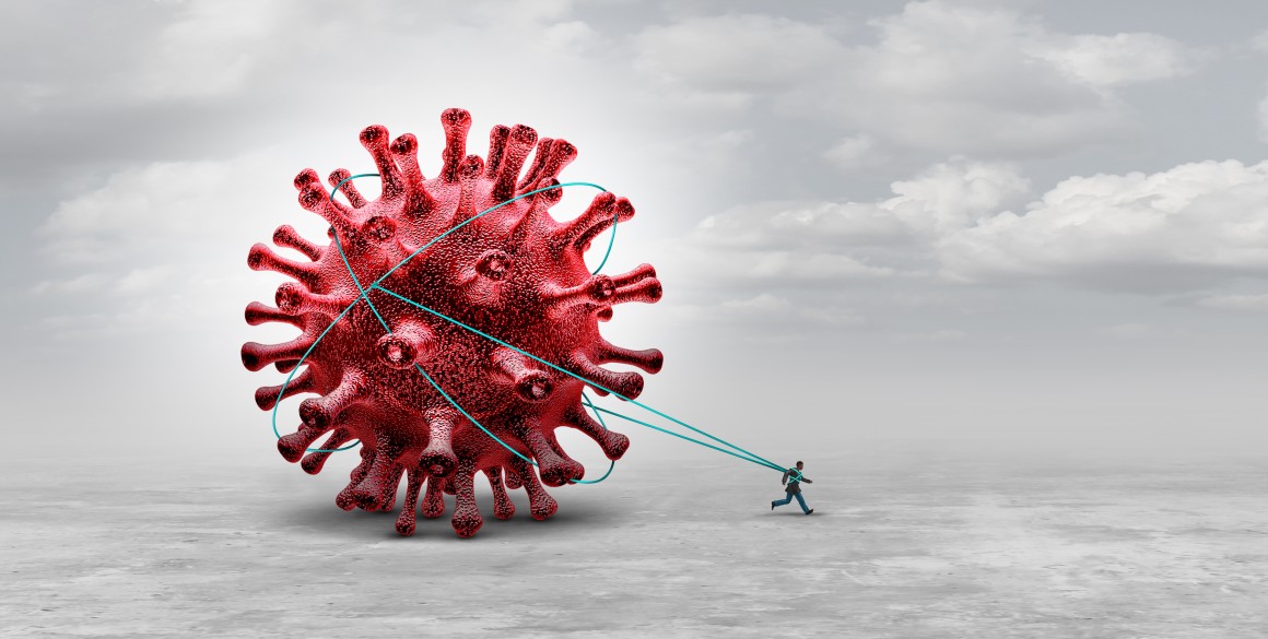 Metaphical image of a small man running, tied to a large coronavirus particle, implying the virus is holding him back.