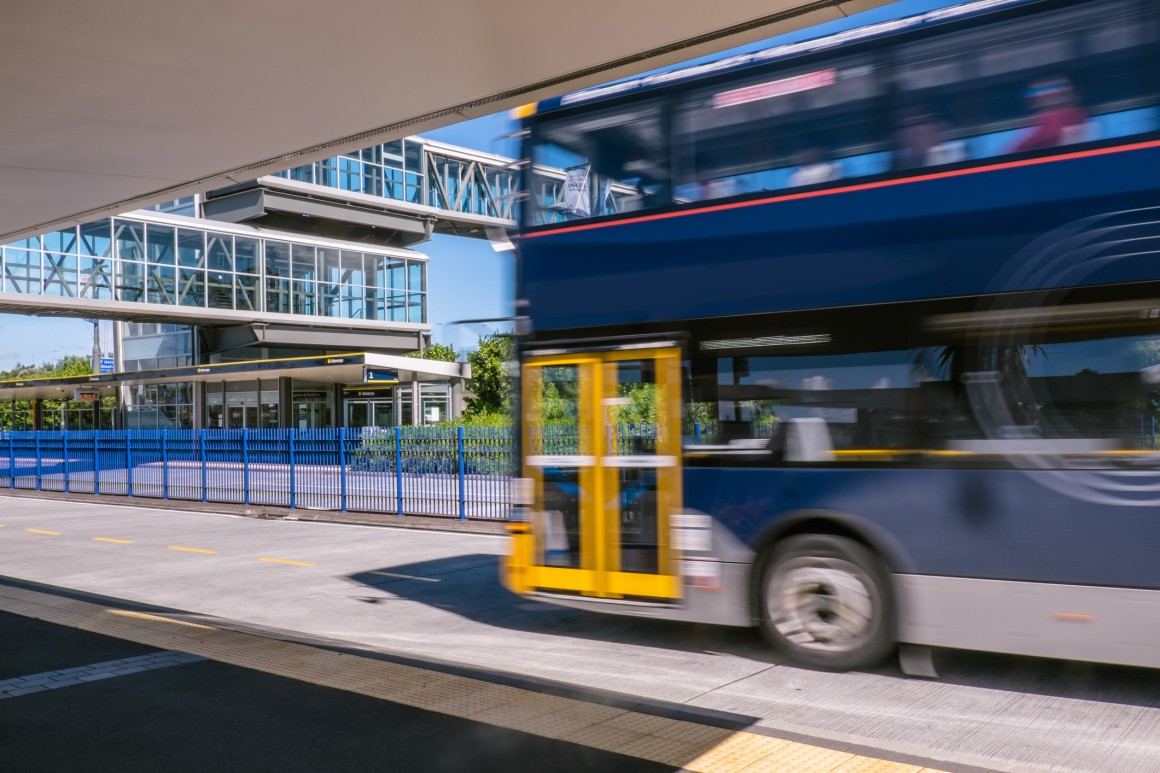 Blurred moving bus at park and ride transport station busway on North Shore, 