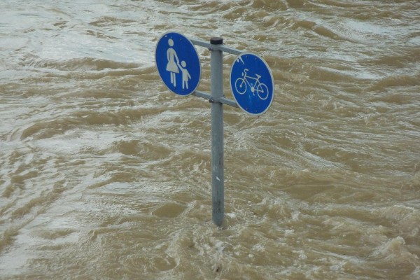 Street signs almost submerged in floodwaters