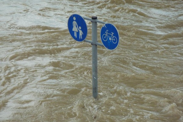 Street signs almost submerged in floodwaters