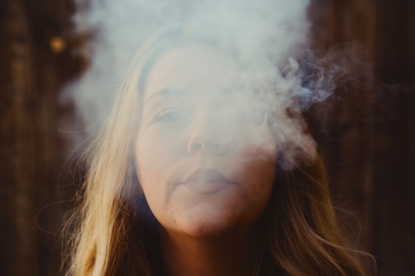Woman surrounded by vape smoke