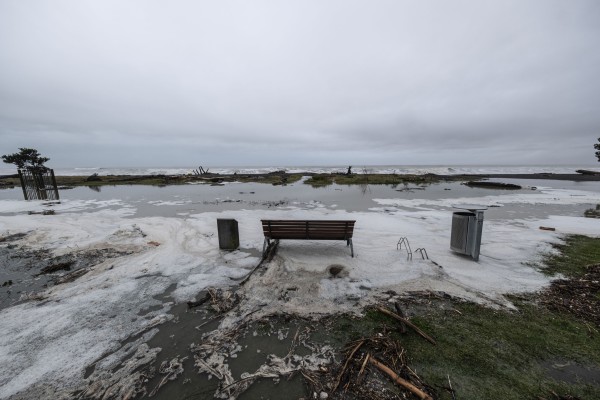 Empty park bench in floodwater on Napier seafront following Cyclone Gabrielle
