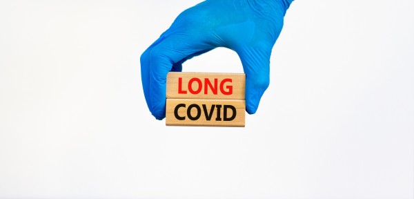 surgical gloved hand and words long covid