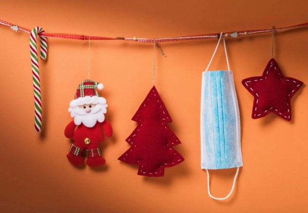 Christmas decorations and a facemask hanging on a string
