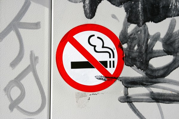 Non smoking sign and graffiti on wall