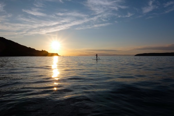 paddleboarding at sunset