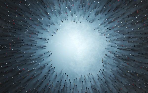 sky view of lots of people surrounding a hole