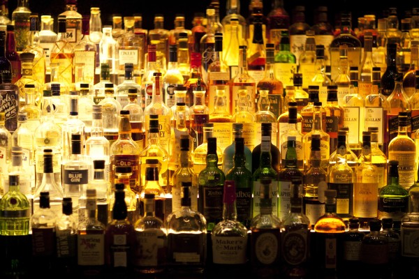 shelves of alcohol bottles backlit