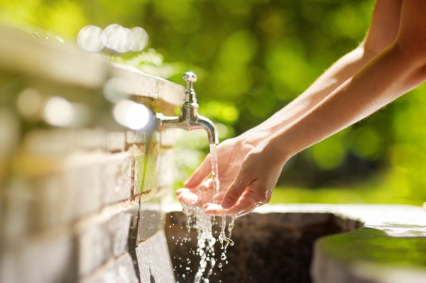 Hands washing in outdoor tap water