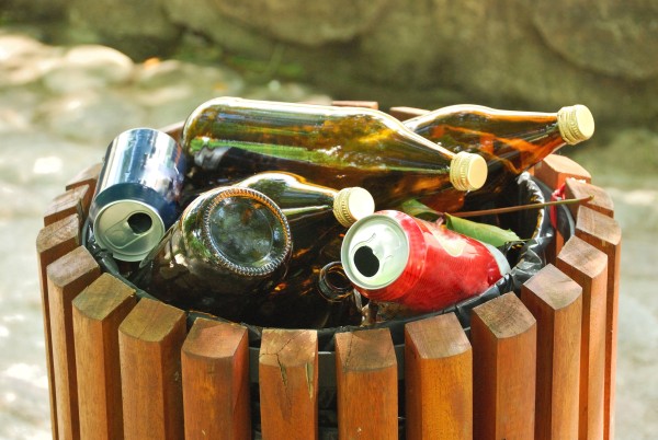 Rubbish bin brimming with empty alcohol bottles
