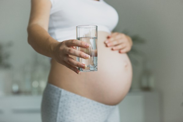Pregnant woman holding glass 